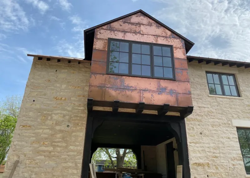 Copper metal panel facade on a stone building for Skylight Installation in Englewood